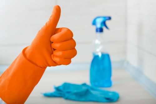 Vacuuming a fabric sofa during routine upholstery maintenance